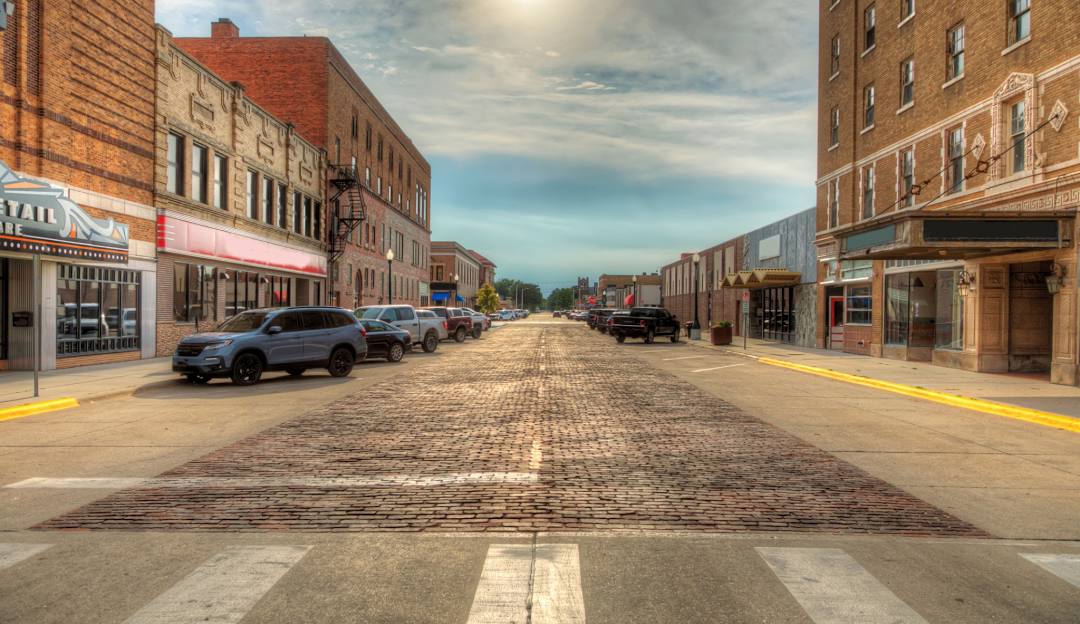 Downtown Ogallala, Nebraska with historic brick buildings and blue sky